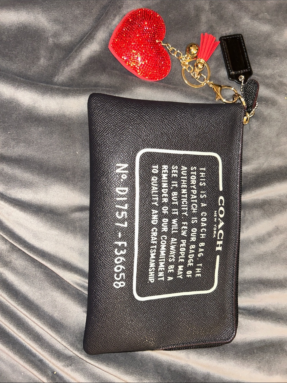 Coach Black Pouch with Red Glitter Heart Charm. Has a wrist strap as well.